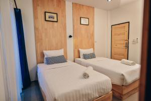 Postel nebo postele na pokoji v ubytování The Cozy Hotel
