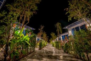 a street at night with houses and trees at Sara Resort in Koh Rong Sanloem