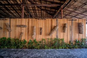 a wooden wall with some bambooaments on it at Sara Resort in Koh Rong Sanloem