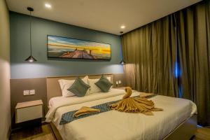 a hotel room with a bed with towels on it at Sara Resort in Koh Rong Sanloem