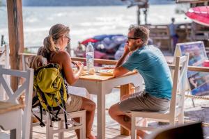 a man and a woman sitting at a table at Sara Resort in Koh Rong Sanloem