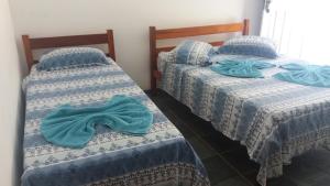 Cama ou camas em um quarto em Lagoa Encantada I
