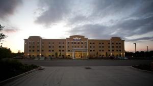 a large building with a sign on the front of it at Baymont by Wyndham Erie in Erie