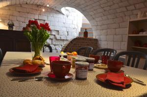una mesa con platos y tazas en una mesa con comida en La Ferme du Bois Quesnoy, en Saint-Pol-sur-Ternoise
