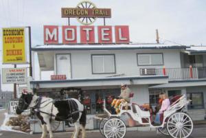 a horse drawn carriage in front of a motel at Oregon Trail Motel and Restaurant in Baker City