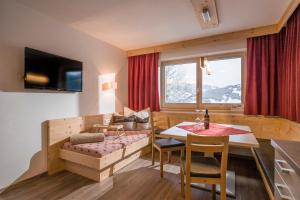 a small living room with a table and a couch at Alpenchalet Zillertal in Hippach