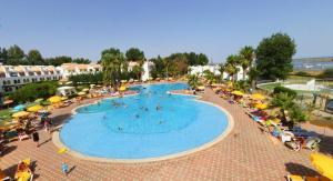 an overhead view of a swimming pool with people and umbrellas at Excellent Golden Apartment in Cabanas de Tavira