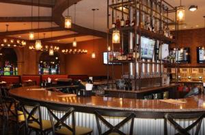 a bar with a large wooden counter in a restaurant at Argosy Casino & Hotel in Kansas City +15 photos