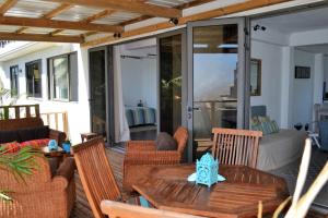 a patio with a wooden table and chairs at 21LG Le Benitiers View in La Gaulette