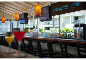 a bar in a restaurant with glasses of wine at Hyannis Harbor Hotel in Hyannis