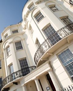 a large white building with balconies on it at Drakes Hotel in Brighton & Hove