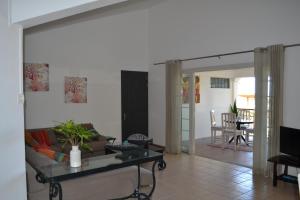 a living room with a couch and a table at 21LG Le Petit Morne in La Gaulette