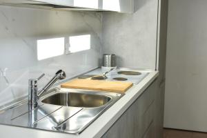 a kitchen with a stainless steel sink and a stove at AltanaParlamento in Rome