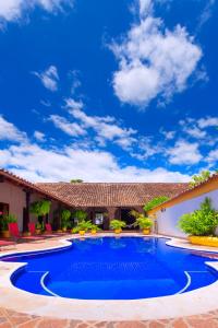 a swimming pool in front of a house at Legado de la Marquesa in Mompos