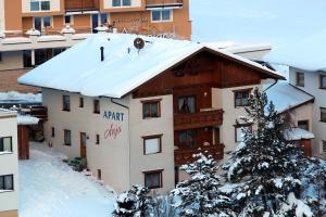 a apartment building with snow on the roof at Apart Anja in Ischgl