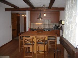 a kitchen with a large wooden table and chairs at Les Boucanier in Verbier