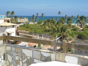 a view of the beach from the balcony of a building at Casa Italiana 100m mar in Salvador