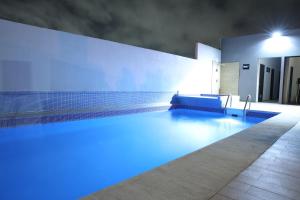 a swimming pool with blue lighting in a house at Hotel Marea Vista in Ensenada