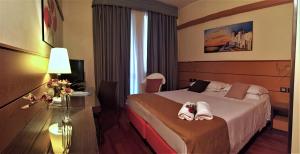 Postel nebo postele na pokoji v ubytování Best Western Hotel Dei Cavalieri