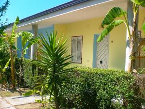 a yellow house with a blue door and a plant at Apartment Jacopo-2 by Interhome in Santa Maria