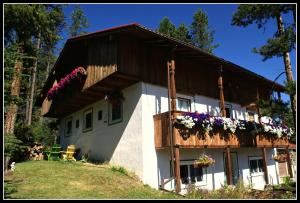 a house with flowers on the side of it at Alpenglow Bed and Breakfast in Kimberley