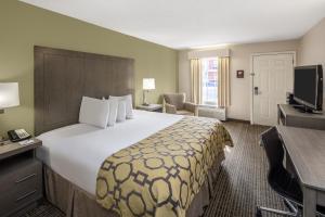 a hotel room with a large bed and a television at Baymont by Wyndham Cleveland in Cleveland +31 photos