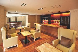 a restaurant with chairs and tables and a bar at Hotel Marine World in Nagasaki