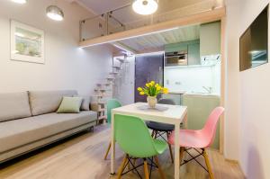 a small kitchen and living room with a table and chairs at Central Krak Apartments in Krakow