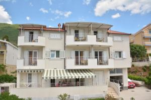 a large white building with balconies on it at Apartment Dakic in Herceg-Novi