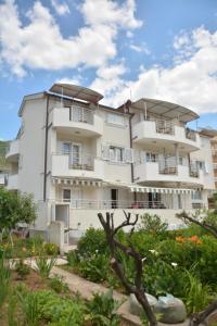 a large white building with balconies on it at Apartment Dakic in Herceg-Novi