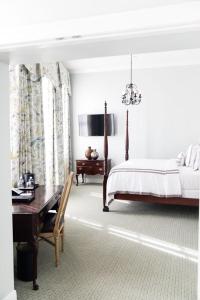 A bed or beds in a room at Bienville House Hotel