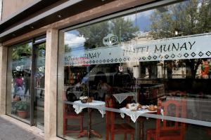 a store window with a table with cakes in it at Munay Salta in Salta