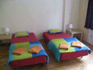 two beds with blue and yellow pillows and two blue and yellow beds at Ragtime in Prague