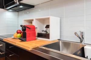 a kitchen with a red appliance on a cutting board at Palo Alto Cottage by Stanford & Tech Companies in Palo Alto