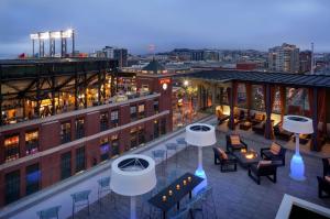 a rooftop patio with tables and chairs on a building at Hotel Via in San Francisco