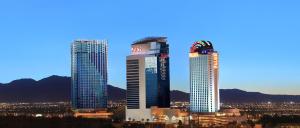 two tall skyscrapers in a city at night at Palms Casino Resort in Las Vegas