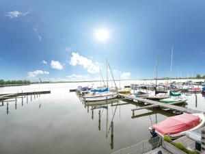 a bunch of boats are docked at a dock at Apartment Oostergeest by Interhome in Uitgeest