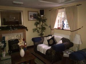a living room with a couch and a window at Grove House - Woodbridge in Woodbridge