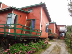 a row of homes with flowers in front of them at Cabañas Don Hugo in Ancud