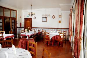 a dining room with tables and chairs with white tablecloths at Ninho do Falcao in Sao Pedro de Tomar