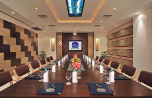 a conference room with a long table and chairs at Best Western Maryland in Chandīgarh