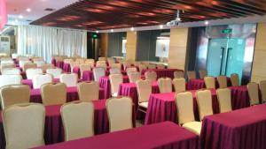 a room with pink and white tables and chairs at Jinjiang Inn –The Mixc Subway, Nanning in Nanning