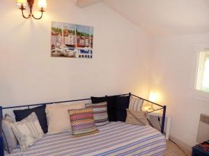 a bedroom with a bed with pillows on it at Holiday Home Domaine des Vignes by Interhome in Cogolin