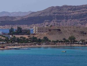 a large body of water with a building in the background at Xperience St. George Sharm El Sheikh in Sharm El Sheikh
