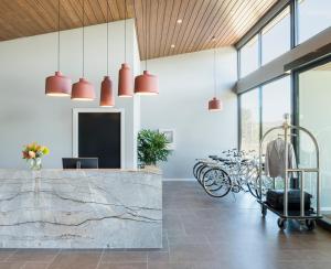 a lobby with red pendant lights and a marble counter at Abode Murrumbateman in Murrumbateman