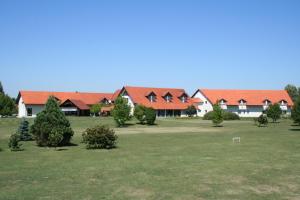 a group of houses with trees in a field at Hotel Golf in Donji Vidovec