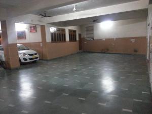 a large empty garage with a car parked in it at Hotel Jai Palace in Ajmer