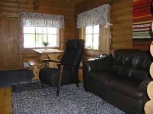 a living room with a couch and a chair at Holiday Home Mökinniemi by Interhome in Soiniemi