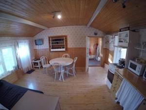 a kitchen and dining room with a table and chairs at Holiday Home Pikku-villa by Interhome in Vähäsalmi