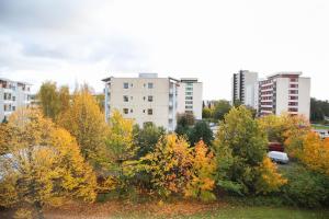 a group of trees with buildings in the background at Apartment Raisio City Center host by B&B Tuure in Raisio +2 photos